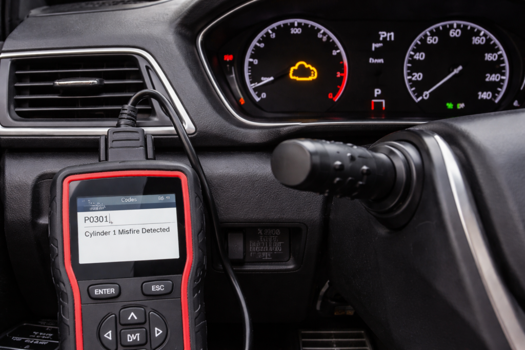 Honda Accord dashboard showing check engine light with OBD scanner plugged in, diagnosing misfire when to change spark plugs in Honda Accord